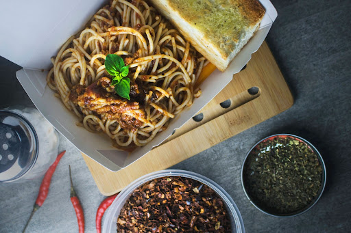 A food delivery container packaged exquisitely for quests ordering food online.